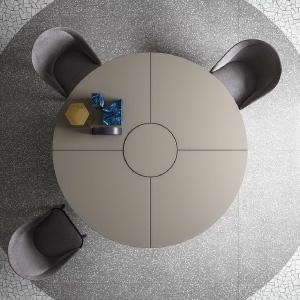 Round beige circular meeting table with armchairs